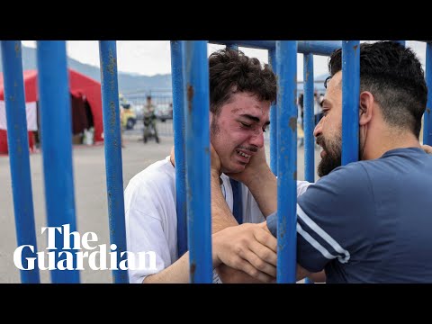 Tearful Greece shipwreck survivor reunites with brother through port gates