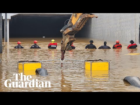 Rescuers try to reach people stuck in flooded tunnel in South Korea
