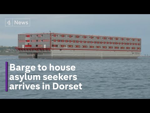 Asylum seeker barge docks in Dorset amidst rival protests