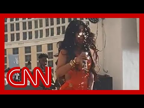 Cardi B gets drink tossed on her, then throws her microphone