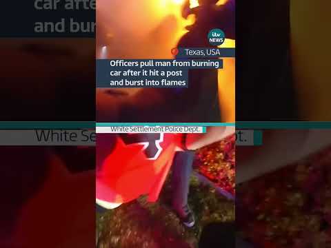 Officers pull man from burning car after it hit a post and burst into flames #itvnews
