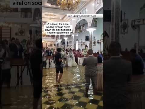 Typhoon Doksuri: Bride in the Philippines wades through floodwater up the aisle