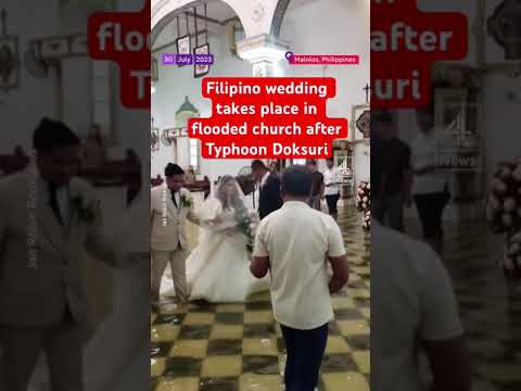 Filipino wedding takes place in flooded church after Typhoon Doksuri