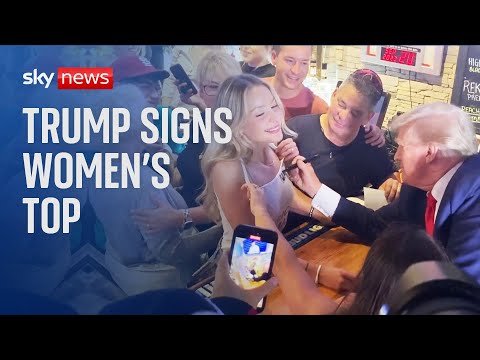Donald Trump signs woman’s top in Iowa restaurant