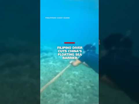 Filipino diver cuts China’s floating barrier
