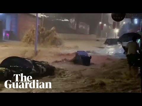 Typhoon Haikui: cars caught up in strong currents of muddy water in China storms