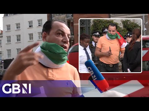 ‘I’m not bothering anyone!’ | Man wearing Palestinian flag removed from outside Israeli Embassy