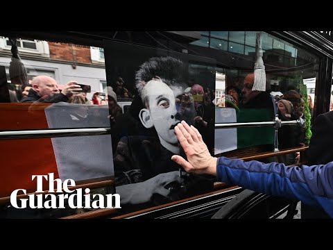 Mourners sing at Shane MacGowan’s funeral procession