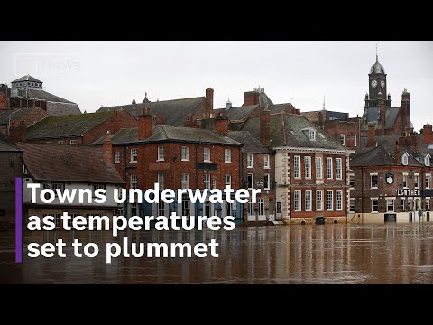 UK flooding: towns underwater as temperatures set to plummet