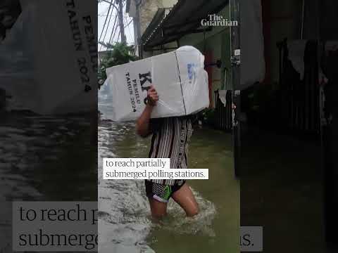 Ballot boxes carried over high water as Jakarta floods during Indonesia election