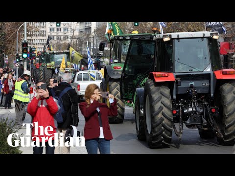 Protesting Greek farmers applauded as they parade tractors out of Athens