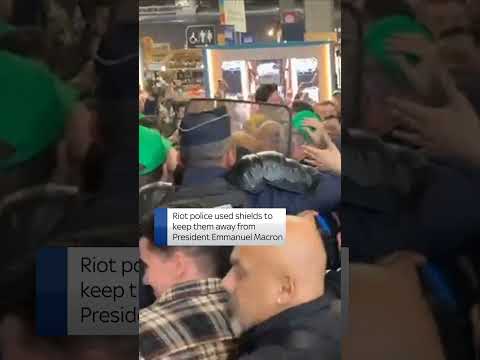 Riot police push angry farmers away from Emmanuel Macron in Paris