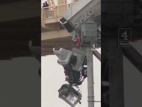Terrifying moment driver is rescued from truck dangling off bridge 70ft in the air