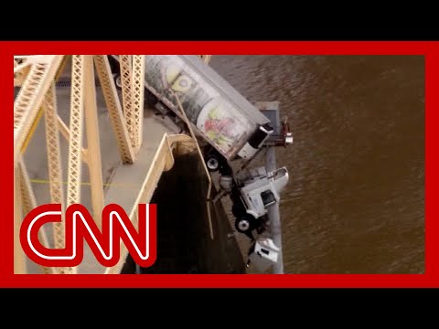 Truck dangles off bridge after crash. See the ‘harrowing’ rescue of driver