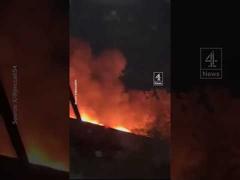 Watch as a train rolls through a Canadian city whilst on fire