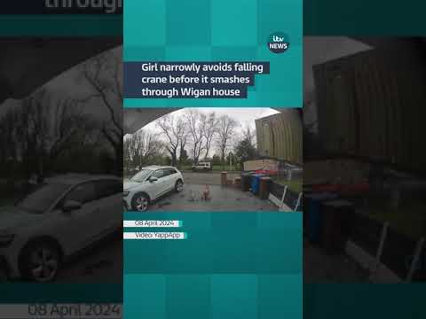 Girl narrowly avoids falling crane before it smashes through Wigan house #itvnews