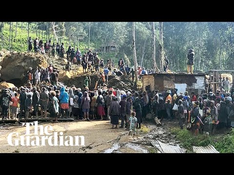 People in Papua New Guinea dig through mud and debris after huge landslide
