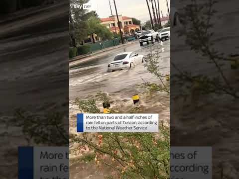 Car pushes through floods