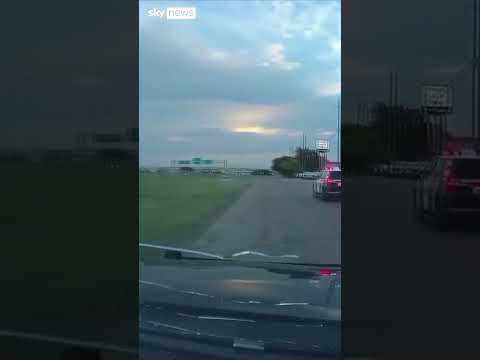 Suspect leans out of moving car and shoots at police