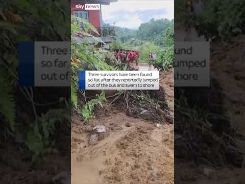 Landslide sweeps two buses into river