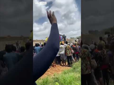 Crowds surround collapsed school