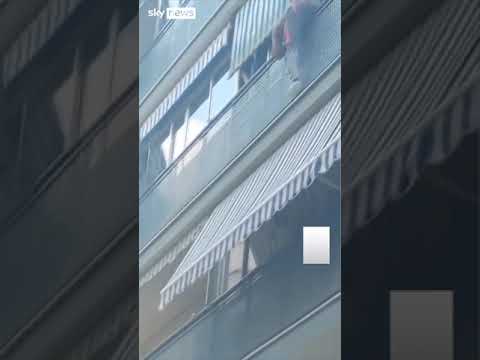 Bricklayer rescues boy hanging over balcony