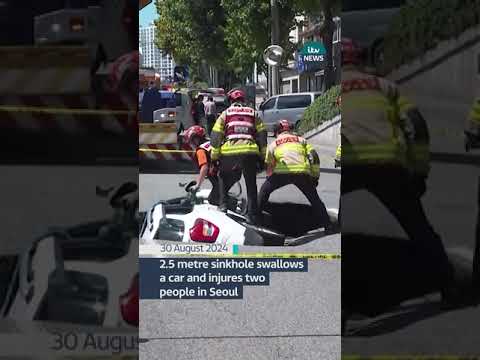 2.5 metre sinkhole swallows a car and injures two people in Seoul #itvnews #news #sinkhole
