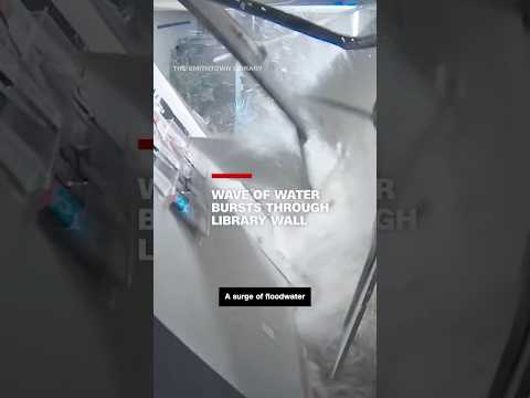 Wave of water bursts through library wall, fills building like a bathtub