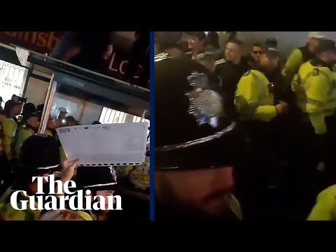Police guide three far-right demonstrators out of a crowd of counter-protesters in Brighton