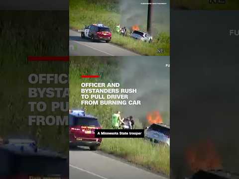 Officer and bystanders rush to pull driver from burning car