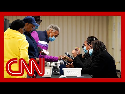 Georgia saw record turnout for first day of early voting. Analysts explain what it may mean