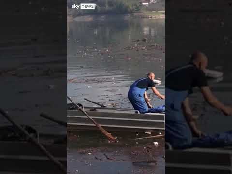 Volunteers clean up lake after deadly floods