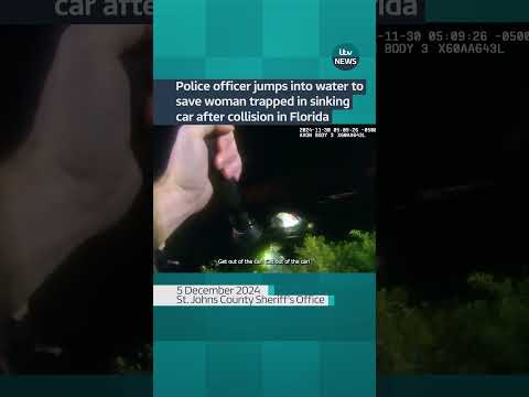 Police officer jumps into water to save woman trapped in sinking car after collision in Florida.