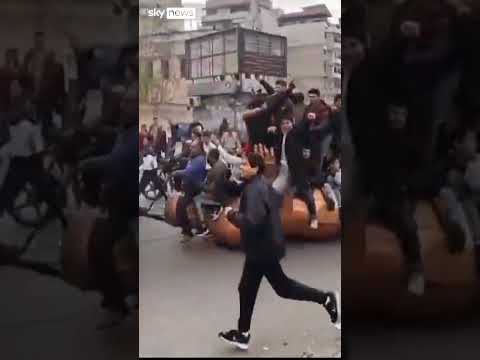 Toppled Assad statue dragged through streets