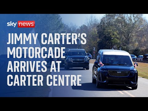 Jimmy Carter’s motorcade arrives at the Carter Centre ahead of funeral