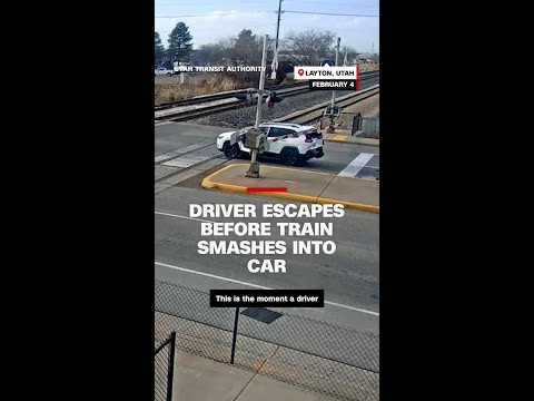 Driver jumps out of SUV moments before train crashes into it