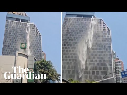 Cascades of water fall down the side of high-rise Bangkok hotel after earthquake
