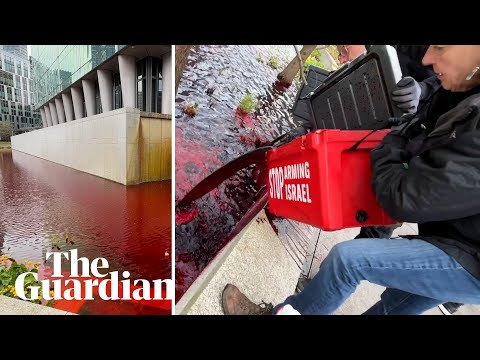 Greenpeace UK activists pour blood-red dye into US embassy pond