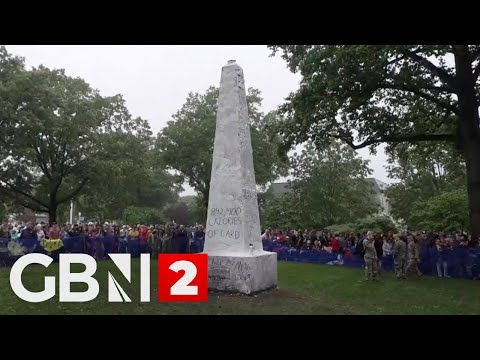 U.S. Naval Academy plebes attempt annual greased climb