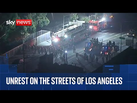 Riot police and National Guard set to enforce LA curfew as violence continues
