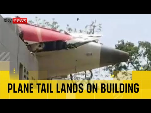 Tail of Air India plane seen on top of building after crash