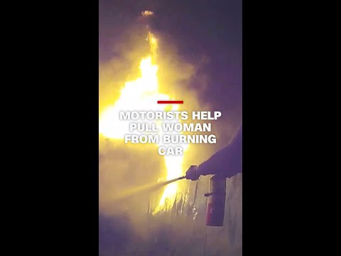 Passing motorists help pull woman from burning car
