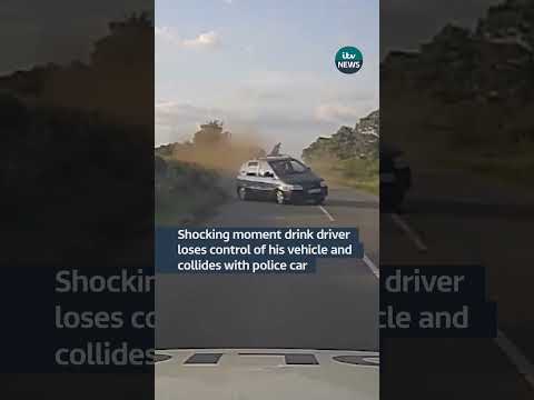 Footage shows the moment a drink driver veered off into a grass verge and collided with a police car
