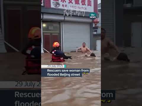 Rescuers save woman from flooded Beijing street #itvnews