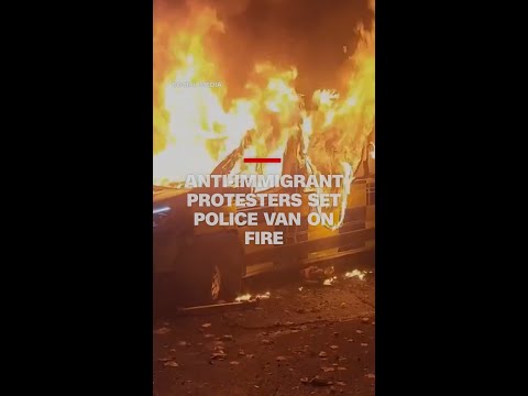 Anti-immigrant protesters set police van on fire