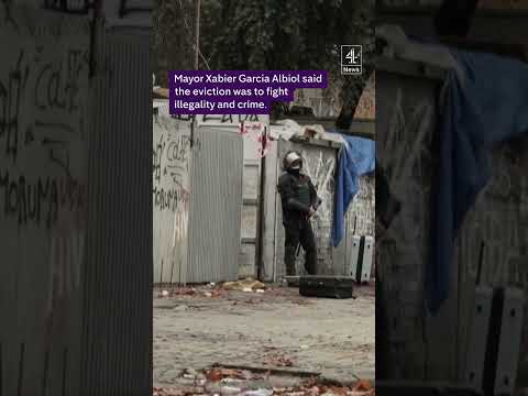 Police evict hundreds of migrants from a squat in Spain.