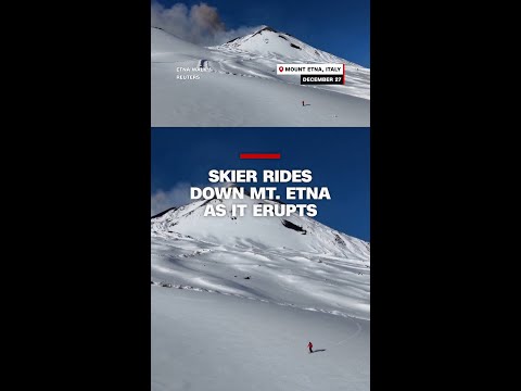 Skier rides down Mt. Etna as it erupts
