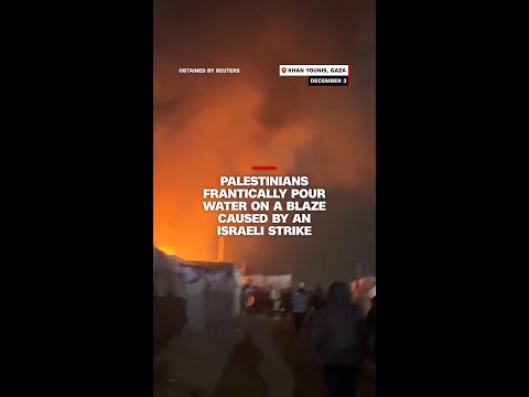 Palestinians frantically pour water on a blaze caused by an Israeli strike