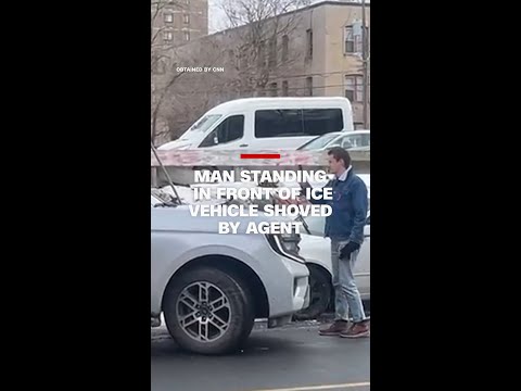 Man standing in front of ICE vehicle shoved by agent