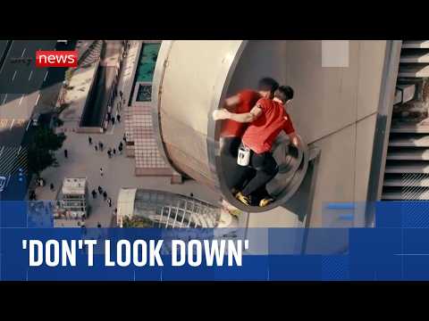 Climber Alex Honnold scales Taipei 101 skyscraper without ropes